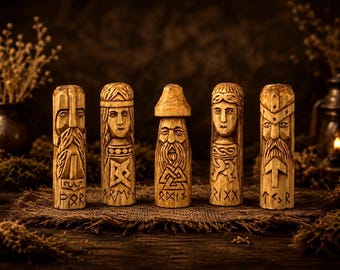 May include: Five cylindrical wooden carvings featuring detailed faces and etched runic symbols. Each figure displays distinct facial features, including beards and headwear, with carved inscriptions at the base reading POR, FRM, ODIN, RIX, and TZR.