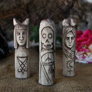Set of black magic figurines. Wooden figurines of Death Lilith and Lucifer.