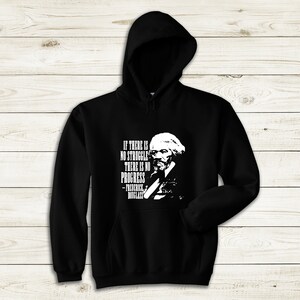 May include: Black hooded sweatshirt with a white print of a quote by Frederick Douglass: "If there is no struggle, there is no progress."