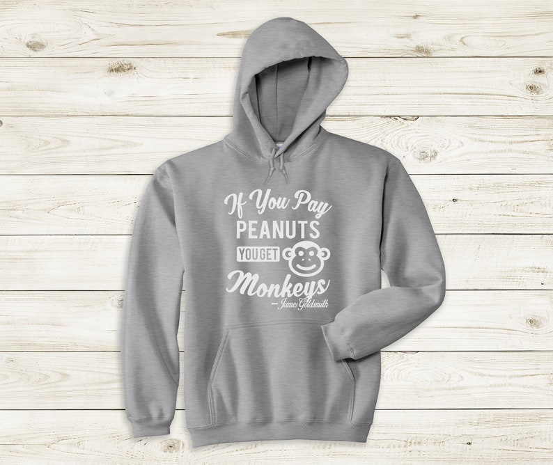 May include: Gray hooded sweatshirt with the text "If You Pay Peanuts You Get Monkeys" and a cartoon monkey face. The text "James Goldsmith" is below the monkey.