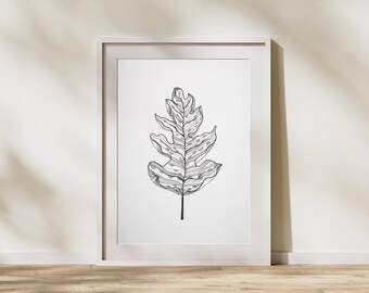May include: A framed black and white botanical art print featuring a detailed illustration of a leaf. The leaf is centered on a white background within a white frame. The artwork is displayed against a neutral wall and wooden floor.