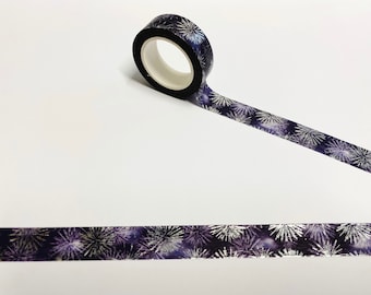 May include: A roll of washi tape with a silver and purple fireworks pattern.