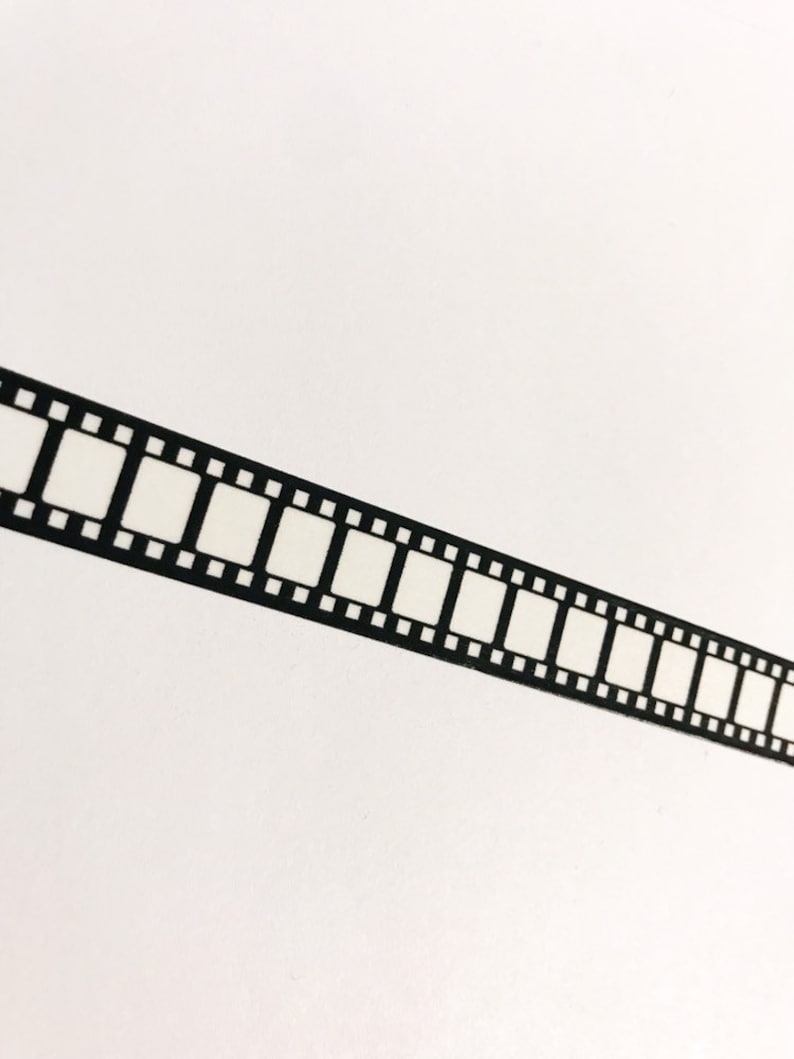 May include: Black and white film strip border on a white background.