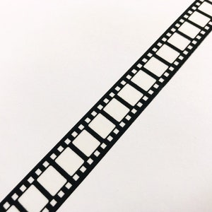 May include: Black and white film strip tape. The tape has a repeating pattern of rectangular frames with black borders.