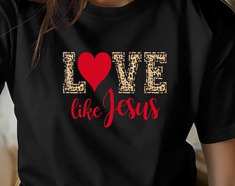 May include: Black t-shirt with a leopard print design and the words "LOVE like Jesus" in red and white. A red heart is in the middle of the word "LOVE".