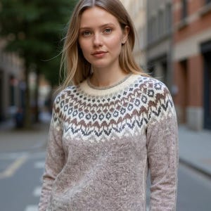 May include: A long-sleeved sweater in a muted mauve color with a patterned yoke in brown, white, and gray. The sweater has a crew neck and a decorative border at the hem. The image includes the text "ChrisVaCreations".