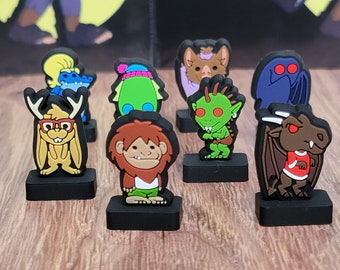 May include: A set of eight colorful character figurines, each with a unique design and personality. The figurines are made of plastic and have a cartoonish style. They are all standing on black bases.