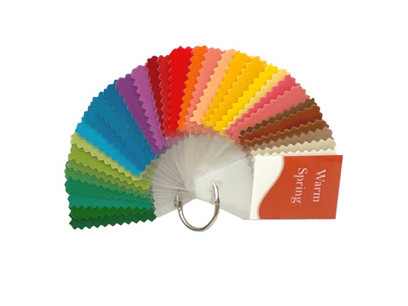 May include: A color palette fan with a variety of warm colors, including greens, blues, yellows, oranges, and reds. The fan is labeled "Warm Spring".