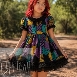 May include: A dress featuring a patchwork pattern of teal, purple, and yellow squares with black stitch-like details. The garment has short puff sleeves, a black Peter Pan collar, and a black lace-trimmed hemline over a layered tulle skirt.
