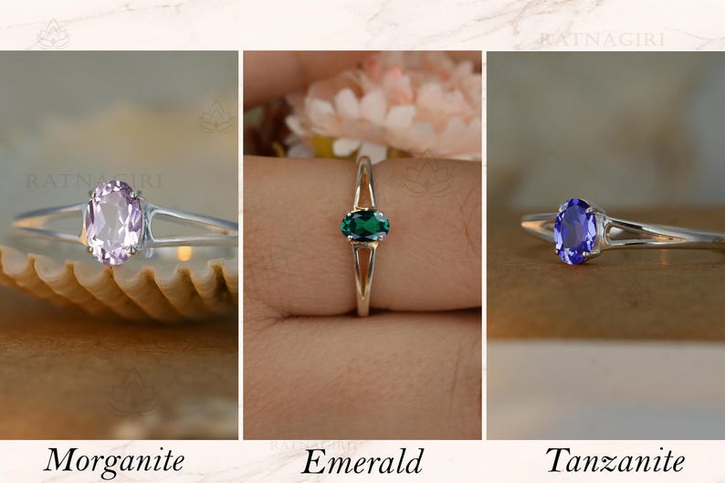 May include: Three rings with oval gemstones: morganite, emerald, and tanzanite. Each ring has a silver band. The morganite ring is light pink, the emerald ring is green, and the tanzanite ring is blue. The word "Morganite", "Emerald", and "Tanzanite" are written below each ring.