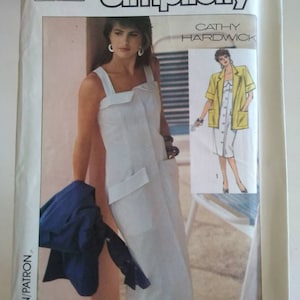 May include: Simplicity sewing pattern for a white sleeveless dress with a button-up front and pockets. The pattern is by Cathy Hardwick and includes instructions for sizes 8-36.