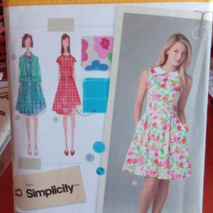 May include: A sewing pattern from Simplicity featuring dress designs. The pattern includes illustrations of dresses with floral and geometric patterns. The package is labeled with the text "lisette SEW YOUR STYLE" and size information.