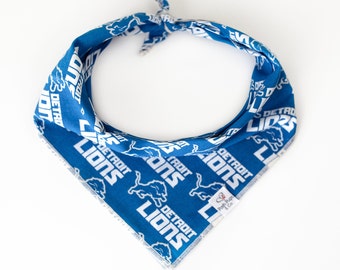 May include: A blue bandana with white text and a lion logo. The text reads "Detroit Lions".