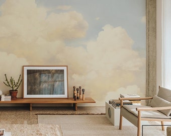 May include: A living room interior with a large wall mural depicting a cloudy sky. The mural is painted in shades of blue, white, and yellow. The room is furnished with two armchairs, a coffee table, and a long wooden shelf. The shelf is decorated with a framed picture, a potted plant, and a few decorative objects.