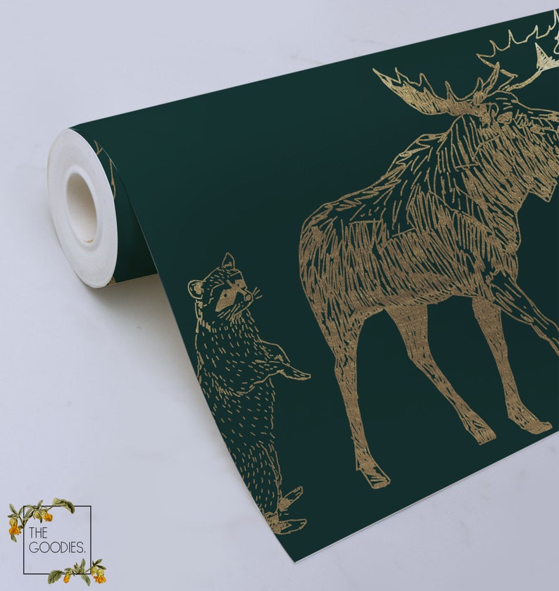 May include: A roll of dark green wallpaper with a gold foil pattern of a moose, raccoon, and other forest animals. The wallpaper is printed with a textured, hand-drawn style.