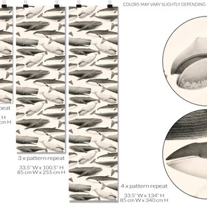 May include: A seamless pattern featuring a repeating design of black and white whales on a cream background. The pattern is shown in three different sizes, with the text "2 x pattern repeat", "3 x pattern repeat", and "4 x pattern repeat" indicating the number of times the pattern repeats. The text also includes the dimensions of each size in inches and centimeters. The image also includes a close-up of a whale's head, showing the detail of the illustration.