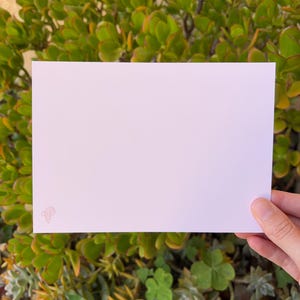 May include: A blank white card with a pink pencil icon in the bottom left corner.