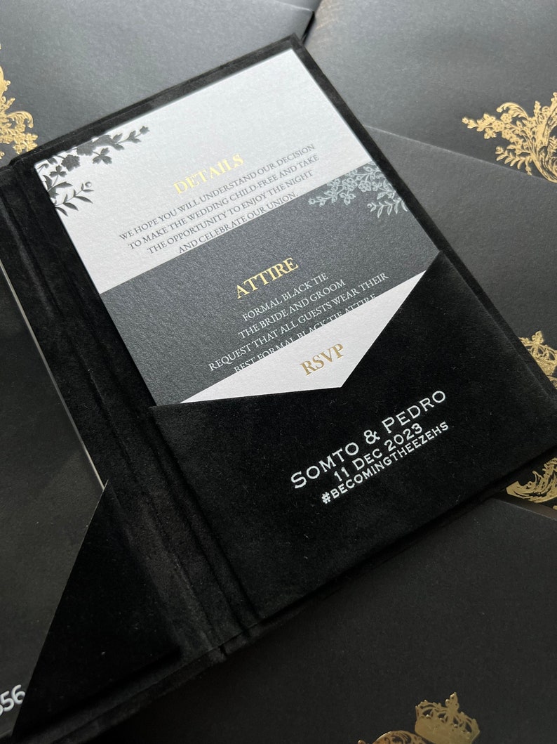 May include: Black and white wedding invitation with gold accents. The invitation features a floral design and the text "Details", "Attire", "RSVP", "Somto & Pedro", "11 Dec 2023", and "#BecomingTheezehs".