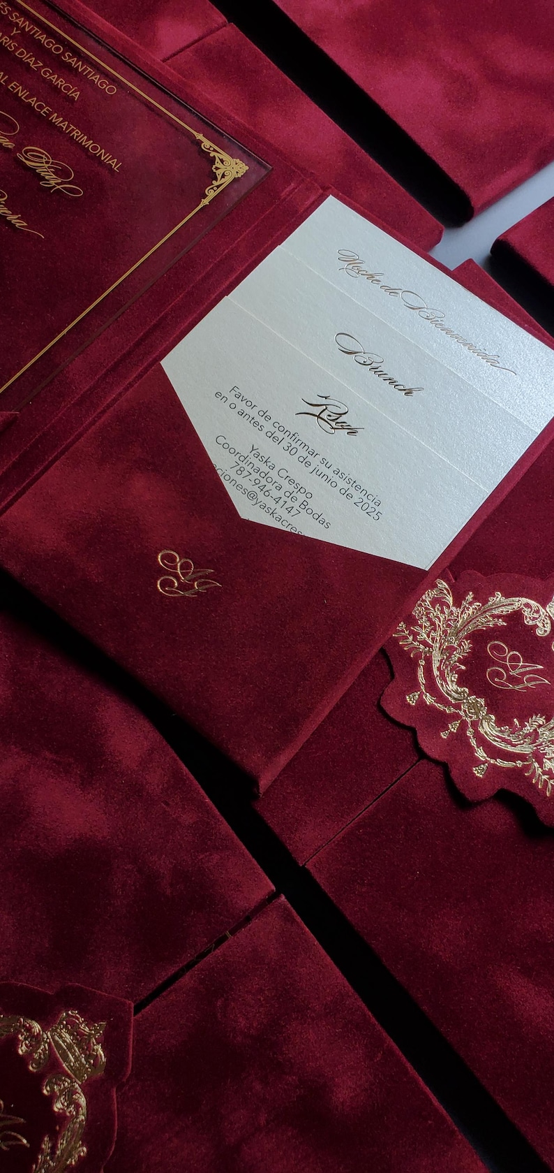 May include: Burgundy velvet wedding invitation suite with gold foil details. The invitation includes the names of the couple, event details, and a request to RSVP by June 30, 2025. The suite includes a decorative tag.
