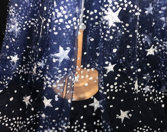 May include: Navy blue tulle fabric with silver glitter stars and dots.