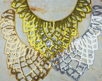 May include: Three gold and silver sequined collars with a geometric design. The collars are layered on top of each other.