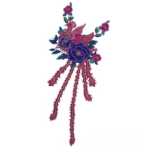 May include: Embroidered patch featuring a pink phoenix with blue and pink flowers and gold accents. The phoenix has long, flowing tail feathers.