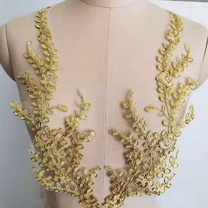 May include: Gold floral lace applique with a delicate design. The lace is perfect for adding a touch of elegance to any project.