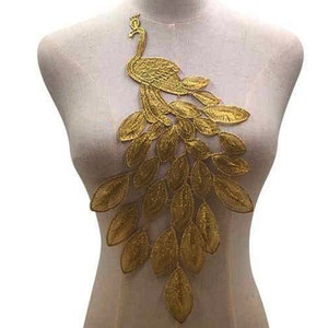 May include: Gold embroidered peacock applique with detailed feathers. This decorative patch is perfect for adding a touch of elegance to clothing, bags, or home decor projects.