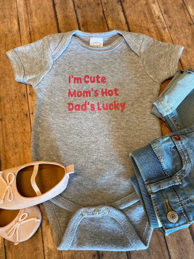 Trendy baby bodysuit available in multi colors! Dad/'s LUCKY I/'m CUTE Funny Baby Bodysuit for your new little one Mom/'s HOT