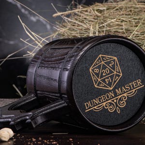 May include: Black wooden beer stein with a handle and a black and gold design of a 20-sided die and the text "Dungeon Master".