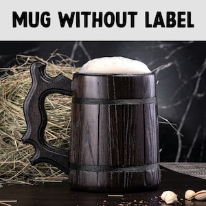 May include: A dark brown wooden beer mug with a handle, filled with a light brown liquid and a white foam head. The mug is sitting on a dark brown surface with a few scattered nuts.