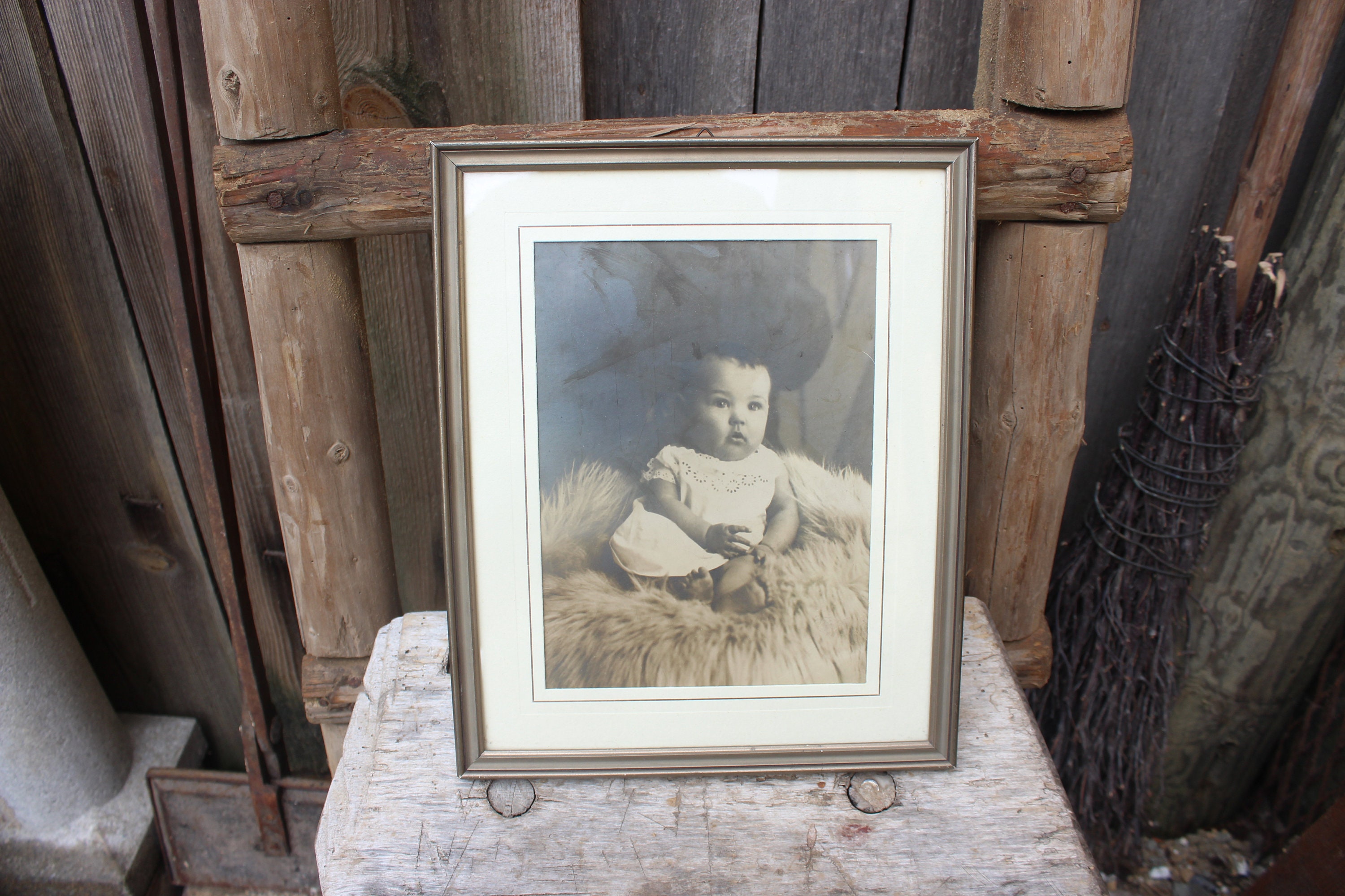 ancient baby photo in wooden frame Baby on sheepskin