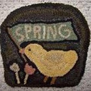 May include: A yellow chick holding a green banner with the word "SPRING" on it. The chick is standing on a brown background with a pink flower.