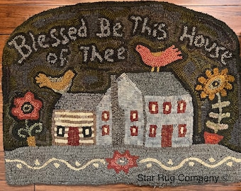 May include: A hand-hooked wool rug with a house, birds, flowers, and the text "Blessed Be This House" in a dark green, brown, and red color scheme. The rug is signed "Star Rug Company".