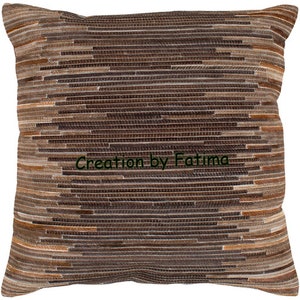 May include: A brown and beige striped throw pillow with the text "Creation by Fatima" in green.