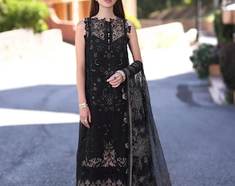 May include: A black long-sleeved dress with a lace overlay and floral embroidery. The dress has a scoop neck and a fitted bodice. The model is wearing a black dupatta with a floral design.