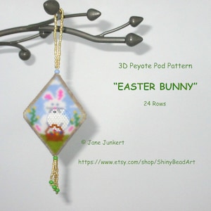 May include: A beaded Easter bunny ornament featuring a white bunny holding a basket of eggs. The ornament is made using peyote stitch and has a green and gold tassel. The text on the image reads "3D Peyote Pod Pattern "Easter Bunny" 24 Rows".