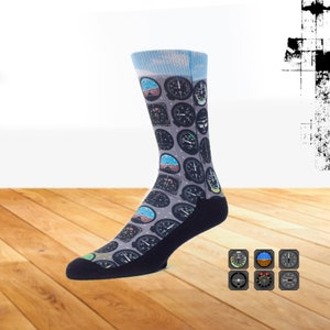 May include: A pair of blue and gray socks with a pattern of airplane instrument gauges. The socks are shown on a wooden floor with a close-up of the gauges on the bottom right.