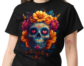 May include: Black t-shirt featuring a colorful sugar skull design. The skull has heart-shaped eyes and is surrounded by vibrant flowers in shades of yellow, orange, and pink. The design is detailed and eye-catching, perfect for Day of the Dead celebrations.
