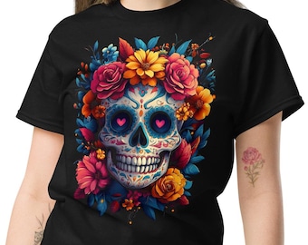 May include: Black t-shirt with a colorful sugar skull design surrounded by flowers. The skull has blue eyes with pink hearts and a white and blue patterned face.