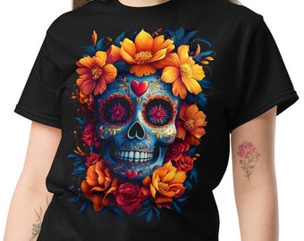 May include: Black t-shirt featuring a vibrant sugar skull design. The skull is adorned with colorful floral accents in shades of orange, yellow, and red. The skull's eyes and forehead have intricate patterns.