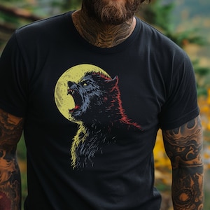May include: A man with long, wavy brown hair and a beard is wearing a black t-shirt with a graphic of a werewolf howling at the moon. The moon is yellow and the werewolf is black, red, and blue.