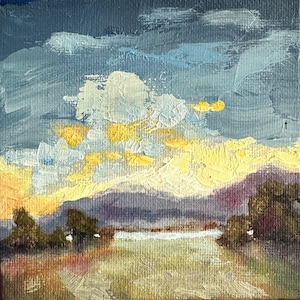 May include: Small square oil painting of a landscape with a sunset. The sky is a mix of blue, white, and yellow, with a mountain range in the background and a body of water in the foreground. The painting has a textured, impressionistic style.