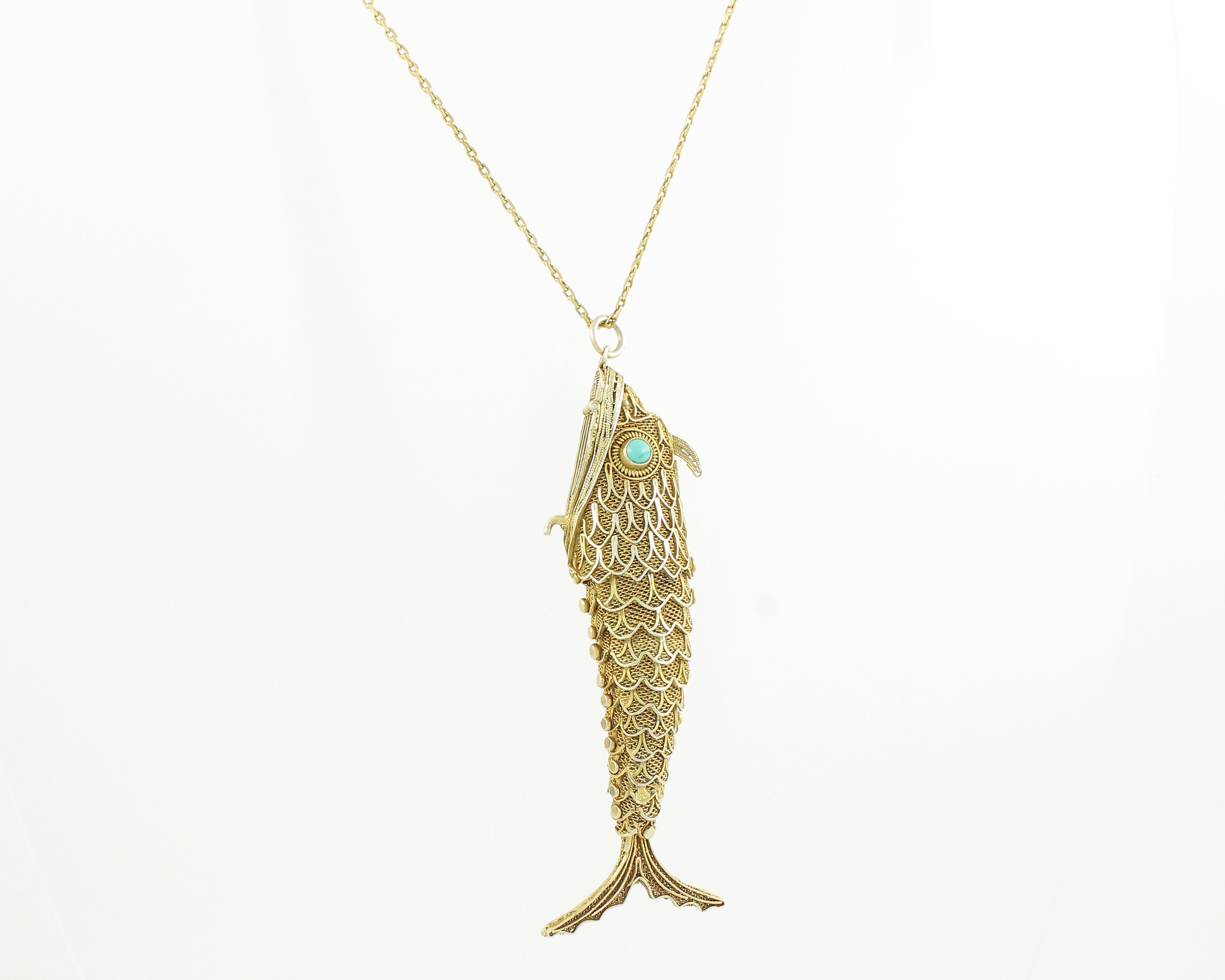 An articulated fish pendant and chain, in - Cheffins Fine Art