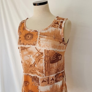 May include: A sleeveless top with a brown and white patchwork design featuring birds, flowers, and cacti.