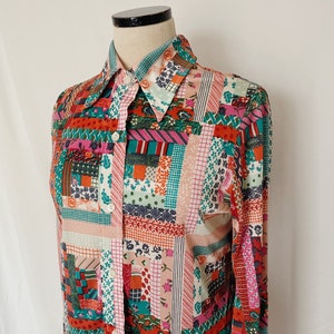 May include: A long-sleeved button-up shirt with a patchwork design. The shirt is made of a soft, lightweight fabric and features a variety of colors and patterns, including pink, red, green, blue, and white.