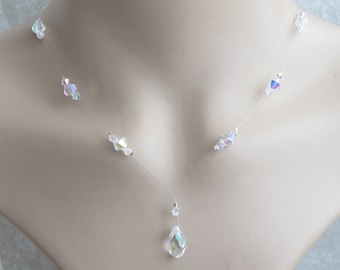 May include: A delicate crystal necklace with a teardrop pendant and small crystal accents. The necklace is made of clear thread and is perfect for a special occasion.