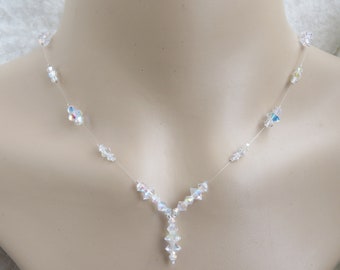 May include: A delicate crystal necklace with a teardrop pendant. The necklace is made of clear crystals and has a silver-tone finish.