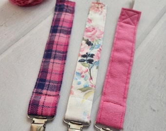 Bright pink pacifier clip set