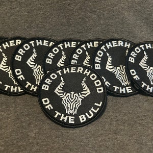 May include: A collection of black circular patches with white text and a bull graphic. The patches read "BROTHERHOOD OF THE BULL" in a circular design. The bull graphic is a stylized white design.